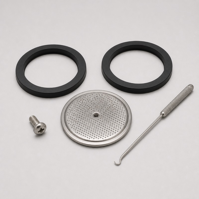 Two black ring gaskets beside a round perforated steel screen, a small screw and a hooked tool