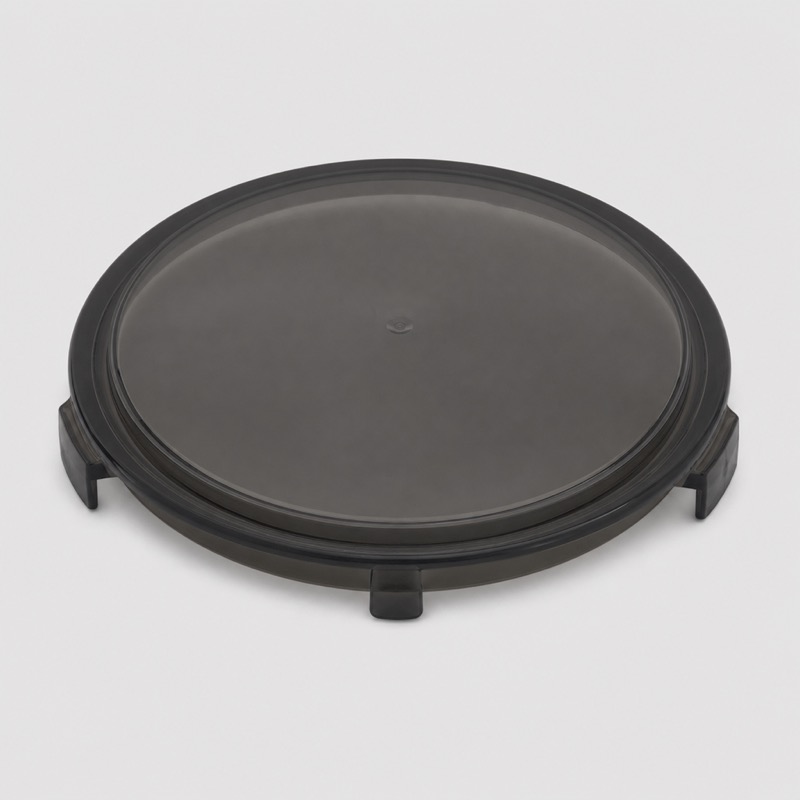 Round black smoked plastic grinder hopper lid seen from above