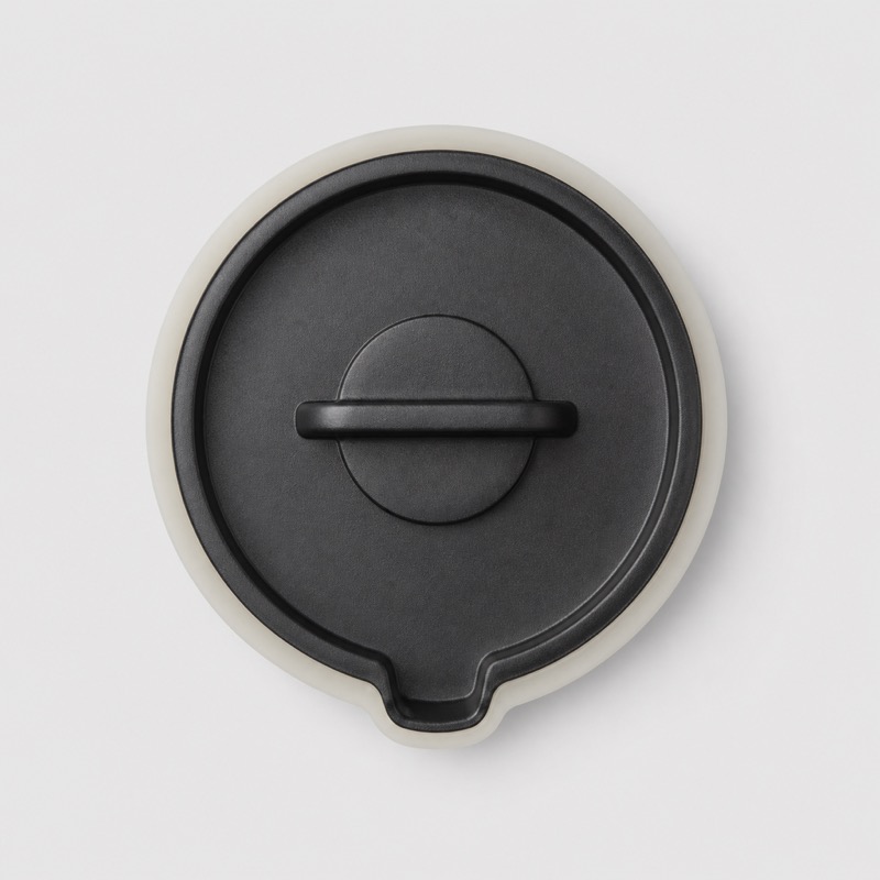 Black moulded server lid with a pouring notch, seen from above